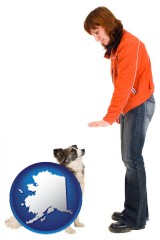 alaska map icon and a woman training a pet dog
