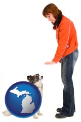 michigan map icon and a woman training a pet dog