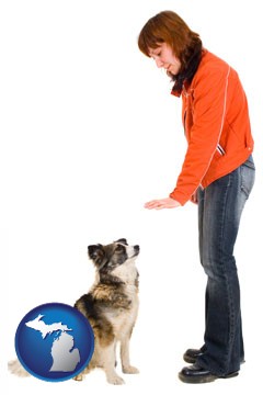 a woman training a pet dog - with Michigan icon